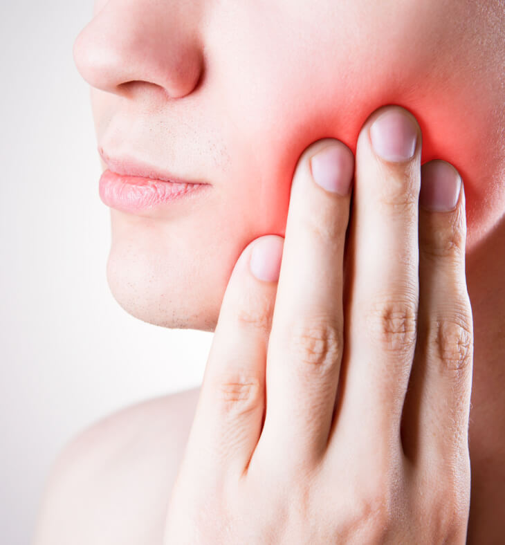 Young woman is suffering from a toothache
